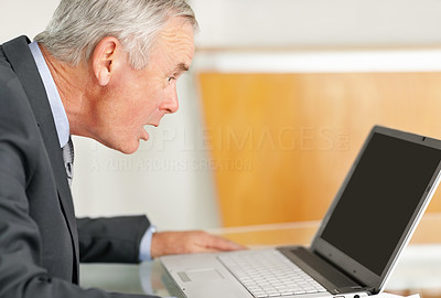 Shocked mature business man looking at laptop screen