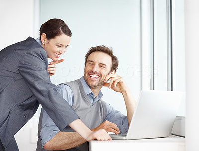 Young man with beautiful business woman working on laptop