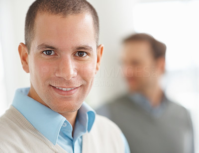 Smiling young man with a person in blurred background