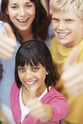 Group of multi ethnic teenagers giving you a thumbs up sign