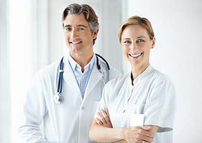 Doctor and nurse standing together with a smile