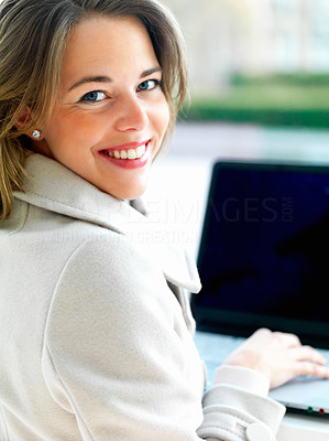 side view of beautiful woman using laptop