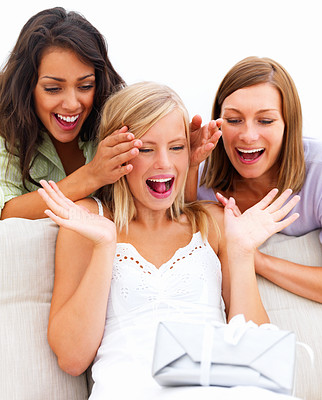 Young women with a happy surprised girl looking at a gift