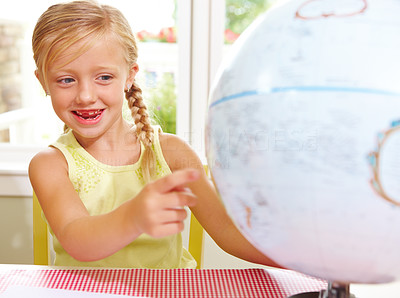 Girl playing with a globe