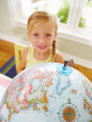 Smiling girl with globe in the foreground