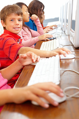 Happy kids sitting together and using computer
