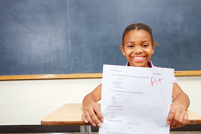 Portrait of a happy young girl showing exam results