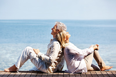 Happy mature relaxing by the sea enjoying life