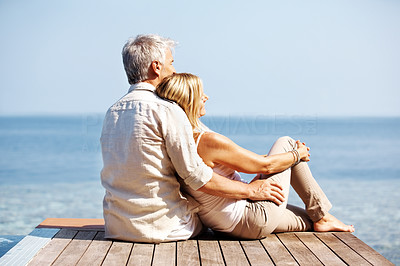 Mature couple spending romantic time together by the sea