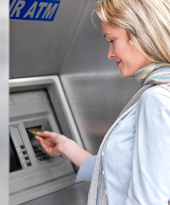 Happy woman withdrawing money
