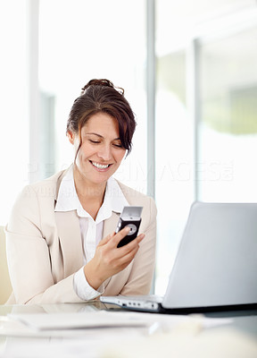 Happy middle aged business woman reading a text message