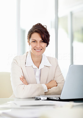 Happy middle aged business woman with hands folded at office