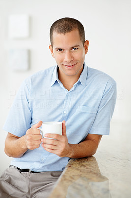 Smiling middle aged man holding a cup of tea or coffee