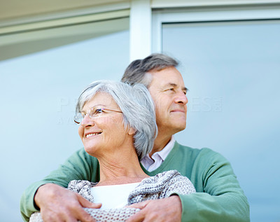 Happy old couple standing together looking away