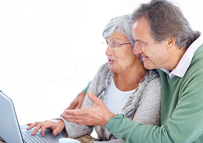 Old man showing something interesting to her wife on laptop