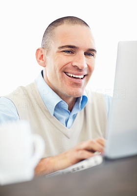 Happy middle aged man working on a laptop