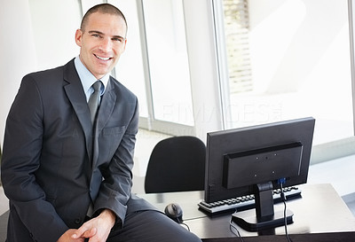 Middle aged business man in office with computer on his desk