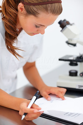 Successful female scientist making research notes
