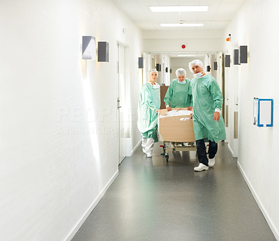 Medical emergency - Doctors wheeling patient through corridor