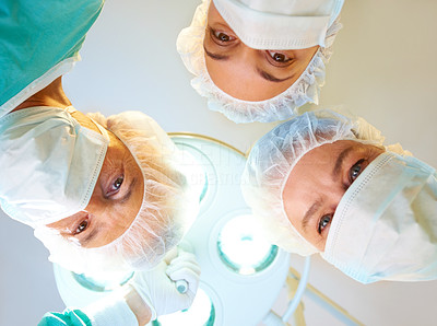 Surgeons looking down at patient in operation room