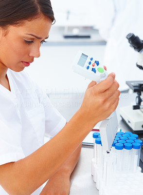Young teenage researcher using laboratory equipments