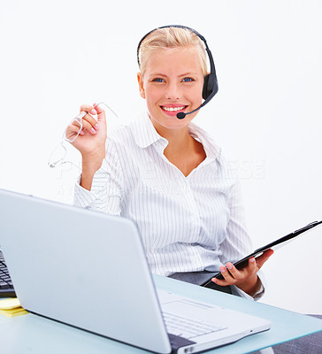 Smiling business woman wearing headset with a laptop and holding glasses, isolated on white