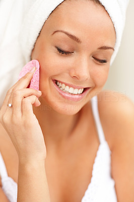 Fresh and beautiful woman wearing white towel on her head cleaning face