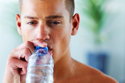 Young man drinking water after a workout