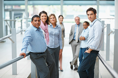 Confident business group standing in modern office