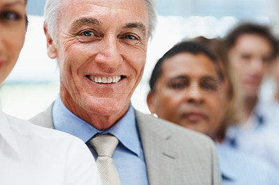 Happy elderly business man in line with colleagues