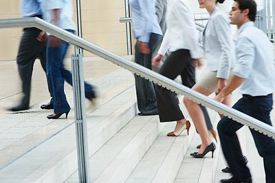 Busy business people ascending on office stairs