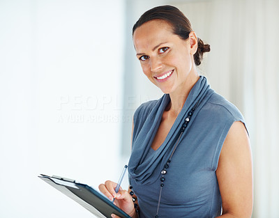Smiling mixed race woman taking notes