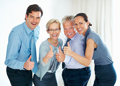 Business team giving thumbs up