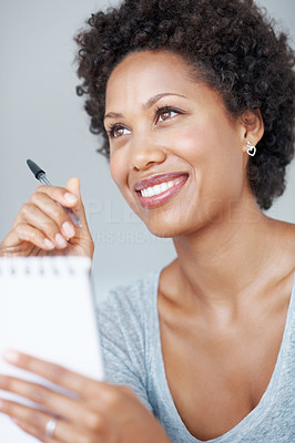 Charming woman writing in notepad