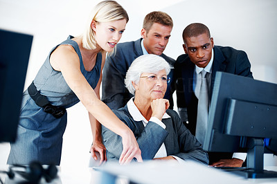 Worried business team looking at computer