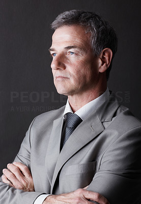 Mature business man in thought against the black background