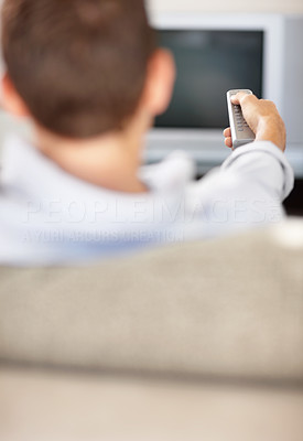 Relaxed middle aged man with remote control changing channel