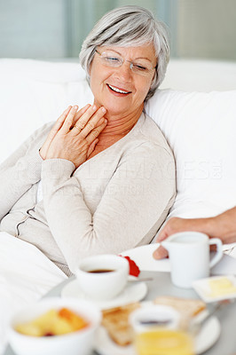 Senior female being served a healthy breakfast at bed