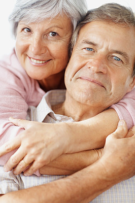 Closeup of a senior couple with arms around each other