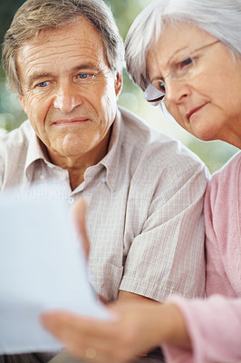 Closeup of a worried couple working on personal finances