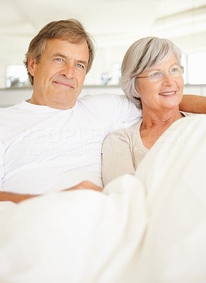 Elderly couple spending a cozy time together in bed