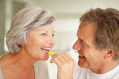 Senior romantic man feeding a woman