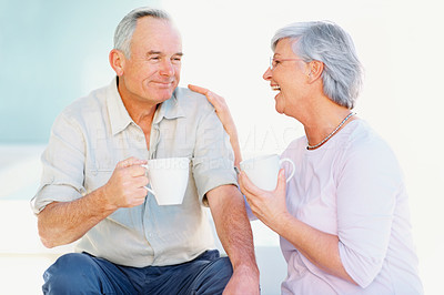 Senior couple sitting and drinking coffee together