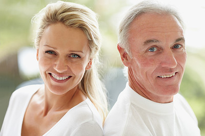 Back to back - Closeup of a cute mature couple smiling