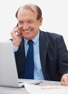 Happy senior business man reading newspaper on the phone