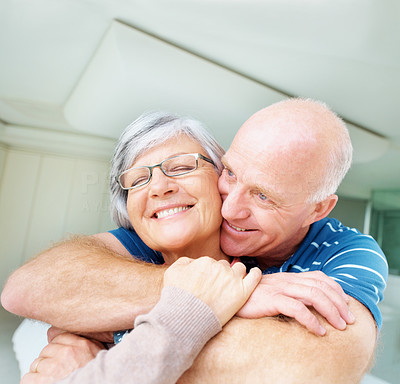 Romantic old man embracing his happy wife from behind