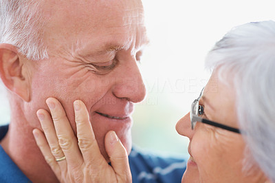 Closeup of a romantic senior man and woman looking at eachother
