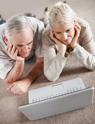 Older couple looking at the screen of a laptop computer