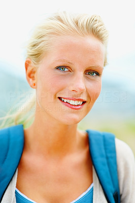 Closeup portrait of pretty college student smiling outdoors