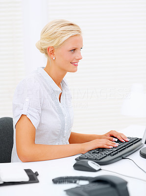 Happy young business woman working on a computer